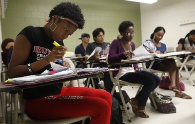 Photo: students sitting at desks doing work