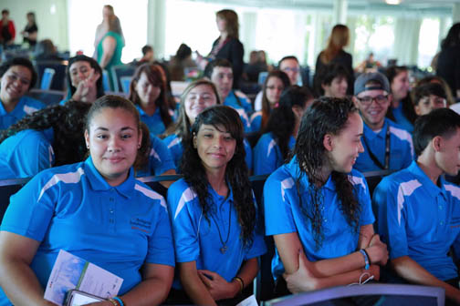 Photo: group of girl students in blue shirts at conference